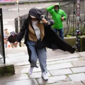 People battle against the wind as they walk along the Royal Mile in Edinburgh.