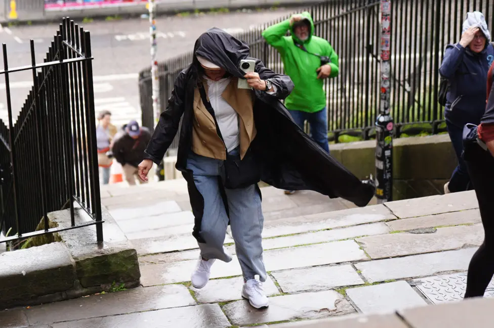 People battle against the wind as they walk along the Royal Mile in Edinburgh.