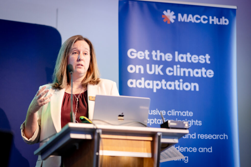 A MACC Hub speaker presents a session at the front stage of the main room during the MACC Hub conference.