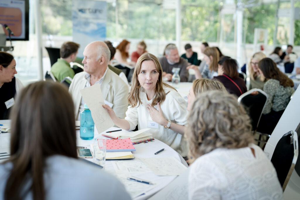 Attendees discuss ideas together during a MACC Hub conference workshop session.
