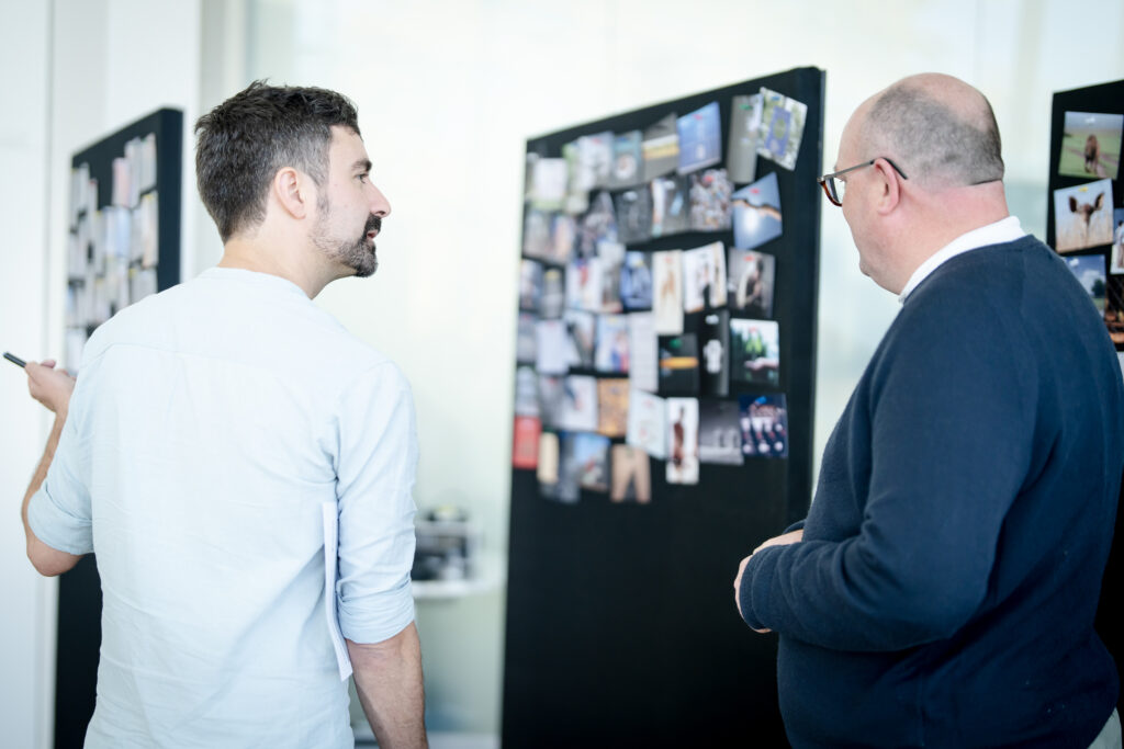 A MACC Hub member speaks with an attendee during a workshop at the MACC Hub conference.