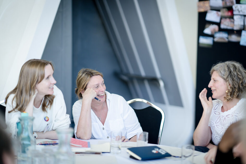 Attendees discuss ideas together during a MACC Hub conference workshop session.
