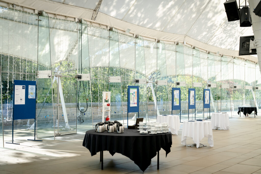 Inside Dynamic Earth venue in Edinburgh, with exhibition stands set up for the MACC Hub conference.